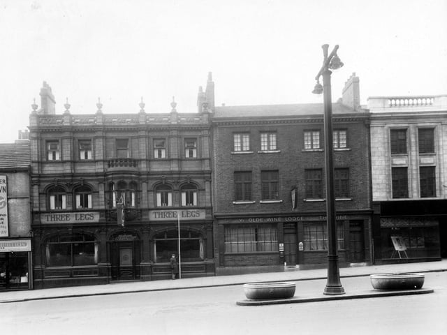 The south side of The Headrow showing Three Legs of Man Inn and The Vine public house. Pictured in December 1949.
