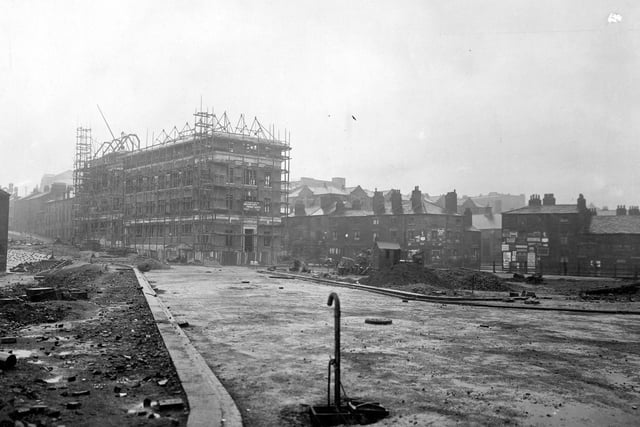 Construction of Eastgate, to be a continuation of The Headrow. This view looks towards Vicar Lane from St. Peters Street. The building under construction is the Kingston Unity Friendly Society Building.