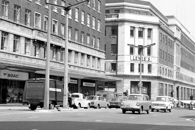 The Headrow from the junction with Albion Street. To the left is Headrow House with shops on the ground floor including B.O.A.C. and Vallance's radio and television engineers. On the right is Lewis's department store.