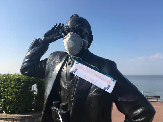 The Eric Morecambe statue wears a face mask and the sign "shouldn't you be at home?"