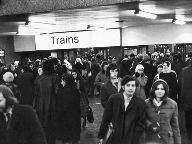 Passengers wait hopefully for trains at Leeds City Station.