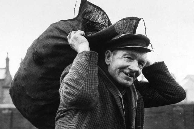 Putting a happy face on the fuel crisis was coalman Arthur Tate who is pictured loading bags of smokeless fuel at the British Fuel Supply Depot in Armley.