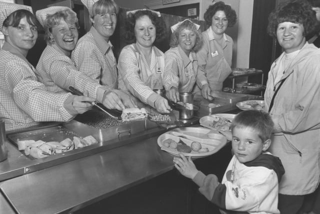 Please can we have some more! Ashley Blake, 4, is pictured with his mum Diane during a preliminary visit to Gladstone Road Infants School. The children who were to start school in September, 1993, were sampling the school dinners. The dinner ladies provide service with a smile.