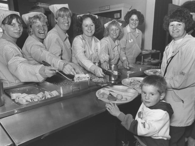 Please can we have some more! Ashley Blake, 4, is pictured with his mum Diane during a preliminary visit to Gladstone Road Infants School. The children who were to start school in September, 1993, were sampling the school dinners. The dinner ladies provide service with a smile.