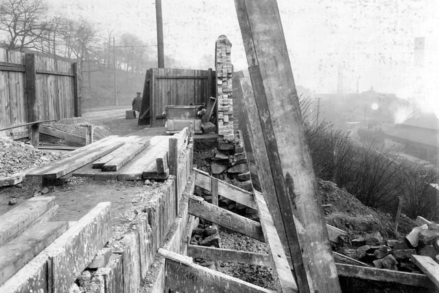 Construction of boundary wall to grounds of Kirkstall Forge. Abbey Road can be seen through the gateway, then construction area.
