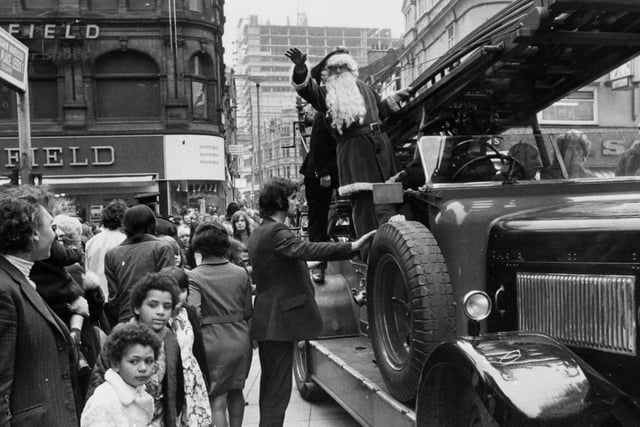 Instead of a sledge, Father Christmas arrives at the Matthias Robinson store in Leeds aboard a veteran fire engine.