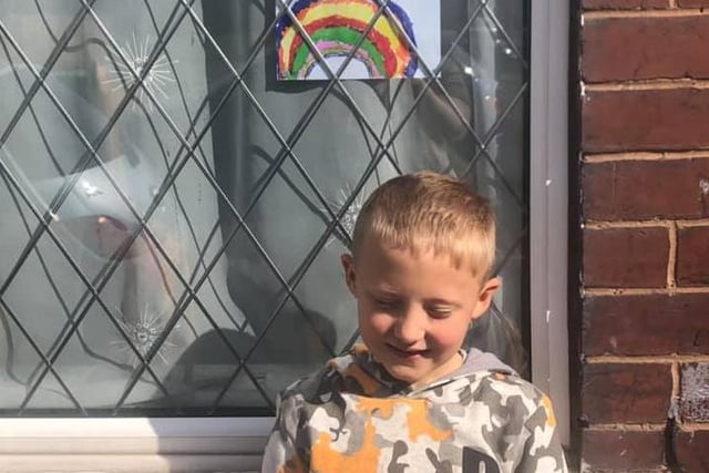 Tommy Calland, 7, from Featherstone stands proudly in front of his rainbow