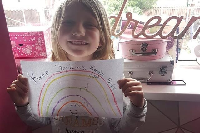 Evie Leigh Schofield, 6, from Castleford looks very pleased with her rainbow