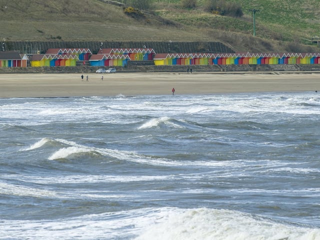 A few people take a walk on a quiet North Bay.