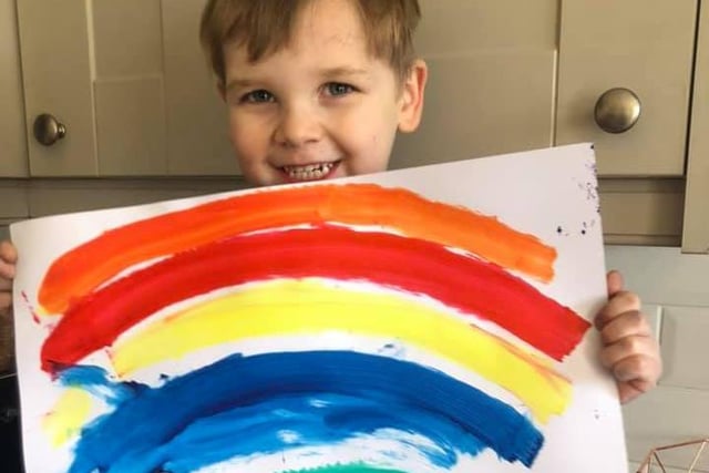 Teddy Johnson, age 3, is very proud of his art work.