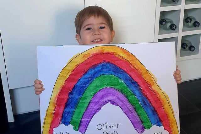 Oliver, age 2, with his big rainbow picture.