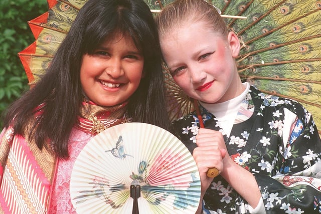 Two girls enjoy the taste of the orient in the June sunshine at Kirkham Club Day