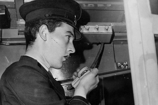 Driver Malcolm Brian uses a new two-way radio fitted in his bus.