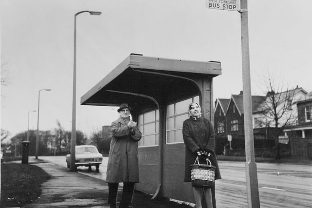 Mr. J. A. Kellis rubs his hands to keep warm at a bus shelter in Alwoodley.