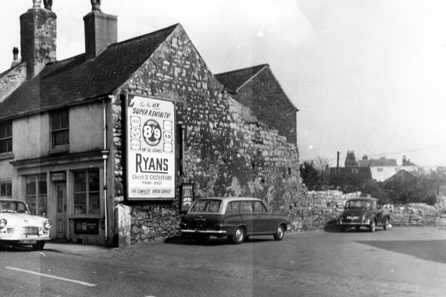Gissing's Barber's Shop in Cross Hills. The gable end displays a large advertisement for T.V. rental at Ryan's in Church Street, Castleford.