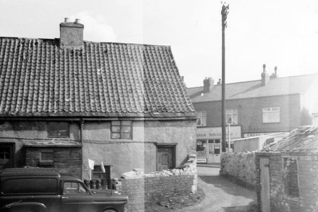 The rear of shop premises of J. & B. Butterfield which sold fish, fruit and vegetables. The Kippax West Riding County Library was adjacent, left. Other premises can be glimpsed in Cross Hills including Cross Hills Fisheries.