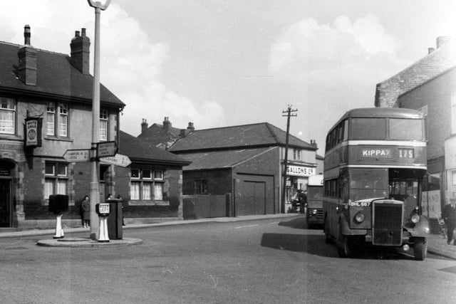 A view of Cross Hills and the White Swan public house seen on the left. The bus is about to make a right turn back around the roundabout as the service terminated at Cross Hills.