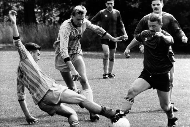 Malcolm Denton (right) of Farsley WMC, in a tussle with Paul Norris and Murray Lumsden, of Regent ACS, during the Leeds Sunday League Division 1 clash.
