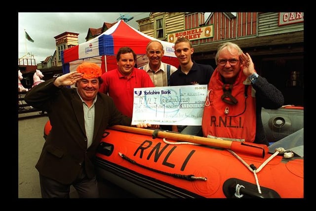 The comedy duo hand over a cheque to RNLI crew member David Warburton at Blackpool Pleasure Beach in 1996