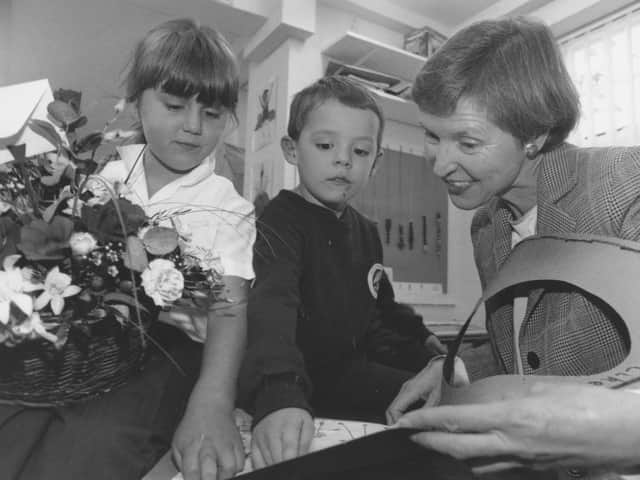 At Hinderwell School open day in November 1996, Sarah Welburn and Daniel Lake look at the basket of planted flowers and book which they presented to Director of Education Cynthia Welburn on her visit to the school.