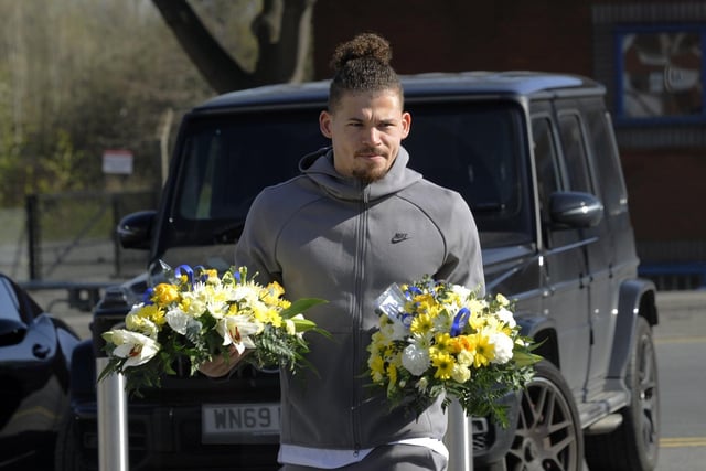 Whites midfielder Kalvin Phillips with flowers in memory of Christopher Loftus and Kevin Speight. Picture by Simon Hulme.