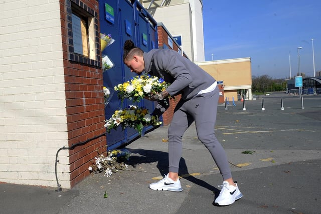 Kalvin Phillips lays the flowers at a very quiet Elland Road. Picture by Simon Hulme.