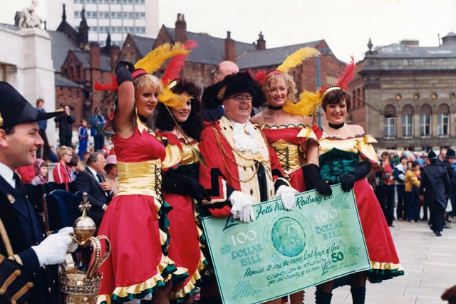 Four 'saloon girls' from Lewis's department store have left their American Wild Western 'steam engine' in the 7th Lord Mayor's Parade to present the Lord Mayor, Councillor Eric Atkinson MBE with a one hundred dollar bill