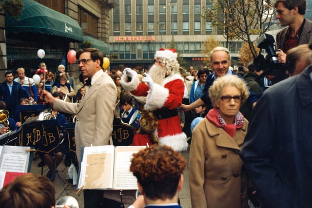 Santa helps to conduct the jazz band playing in Dortmund Square as part of the store's Golden Anniversary celebrations in 1982.