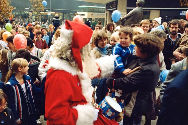 Santa talks to the children among the crowd in Dortmund Square who have assembled to celebrate the Golden Jubilee of Lewis's in 1982.