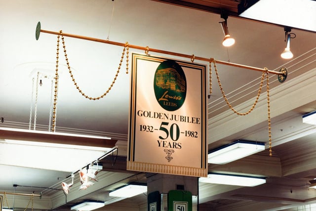 A sign in green and gold is one of many throughout the store in celebration of the Golden Jubilee of Lewis's in September 1982.