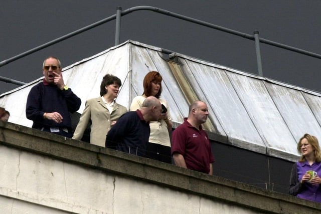 These spectators get a birds-eye view from the top of the Leeds General Infirmary.