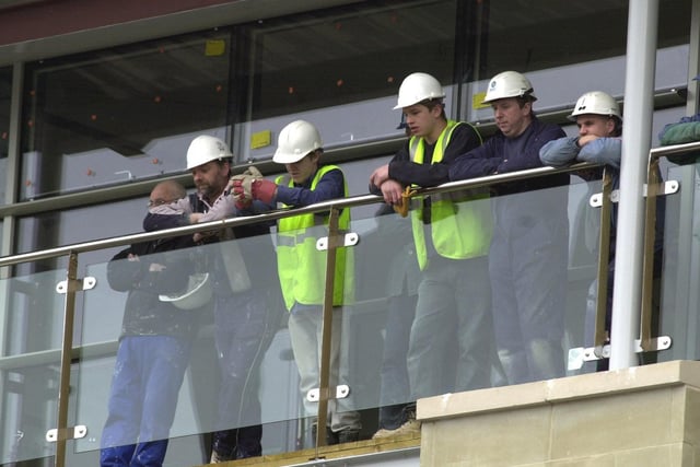 These workmen took advantage of their high vantage point to see Nelson Mandela on stage.