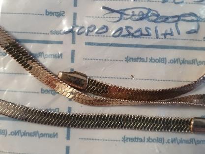 A necklace or bracelet seized by police during burglary investigation.