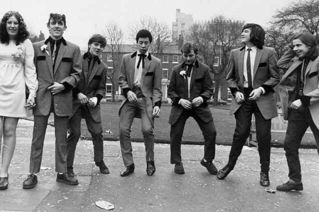 A bride and groom (on left), and five of the the groom's Teddy Boy friends jive in Park Square gardens after a wedding at Leeds Register Office.