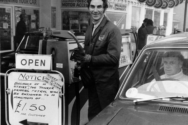 Cyril Hoffman beside the pumps at a filling station in Harehills where customers were being rationed when buying petrol.