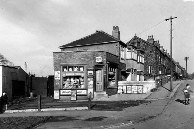 The junction of Bentley Lane with Grove Lane, showing a pair of semi-detached houses, with the premises of E. Hawkshaw, newsagent, on the end.