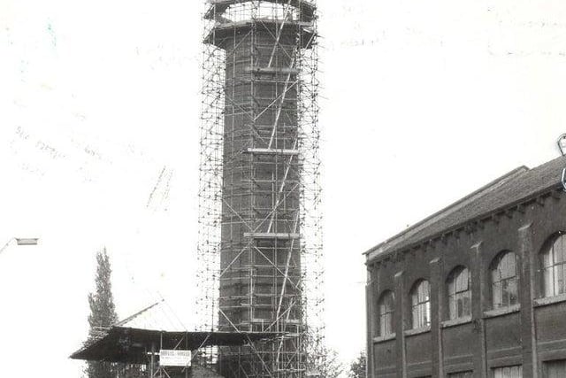 Scaffolding encases the Meanwood chimney as it is demolished brick by brick.
