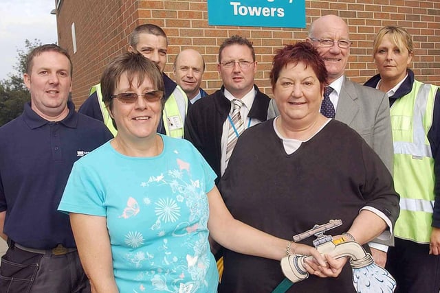 Resident Doreen Bird and Coun Brenda Gabriel with team members who helped to install permanent taps outside Cottingley Towers. Tenants could  water bordering flower beds in order to enter Britain in Bloom.