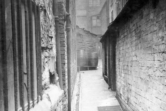Bradleys Yard off Lower Headrow. Have you spotted the man standing in a doorway to a building? This was premises of J.H. Broadbent, shopfitter.