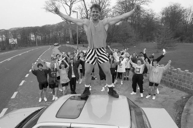 Passing motorists watched as an impromptu aerobics class was held by the side of a busy main road. As cars rushed past, aerobics teacher Kevin Meek put 40 women through their paces in protest at losing his regular venue - Ribby Hall Leisure Village, Wrea Green. He led the ladies through their routine from the top of his car in a lay-by close to Ribby Hall