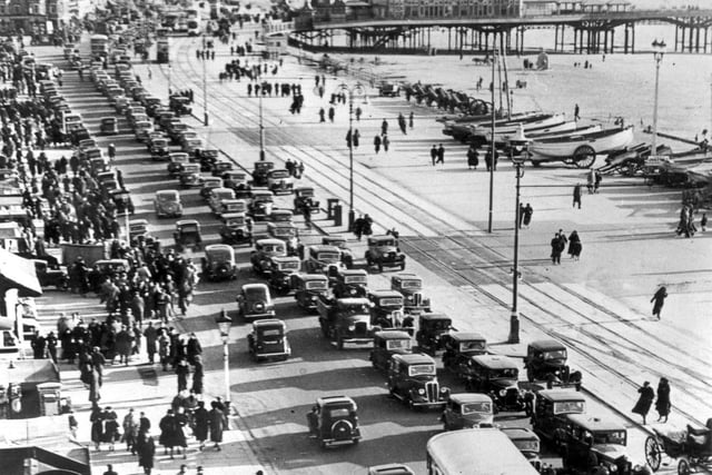 Motor cars and double decker buses dominate this Central Beach Easter holidays scene from the 1950's