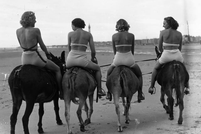 Four bathers on a donkey ride on Blackpool beach at Easter, April 1938