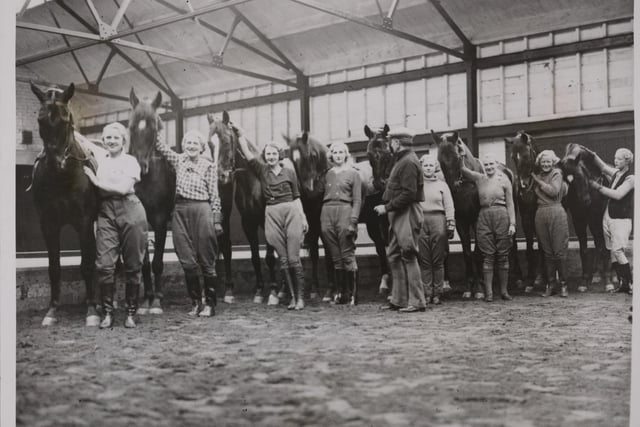 This undated photo from Getty Images, titled Beauties Of The Sawdust Ring, shows eight girls and forty horses who spent Easter busy rehearsing at the circus training grounds in Blackpool for the circus which was due to open at Whitsun.
