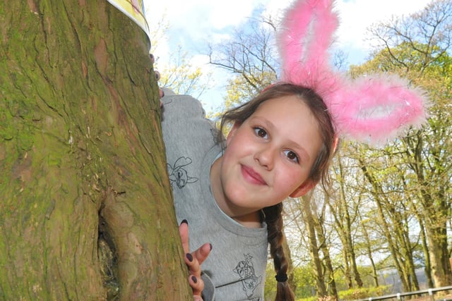 Nikita Rowles, nine, hunts for clues in the park, as families and friends take part in the Easter egg hunt around Haigh Woodland Park, Wigan, raising funds for Three Wishes, Wrightington, Wigan and Leigh NHS Foundation Trust's charity, April 2019.