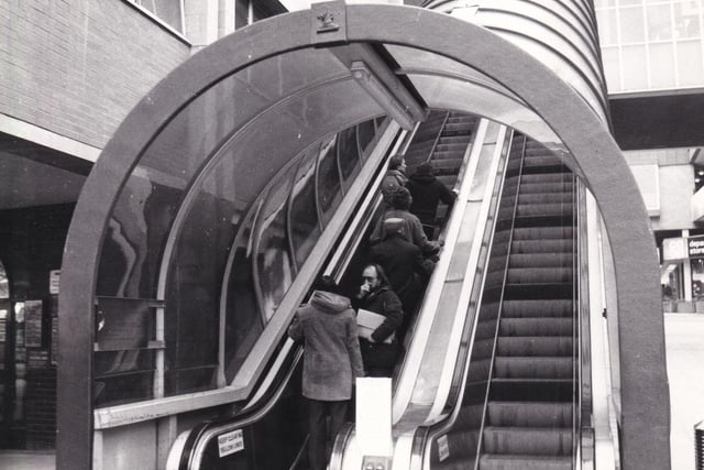 One moving staircase going up, another moving staircase coming down. The escalators on Boar Lane, pictured in November 1980.