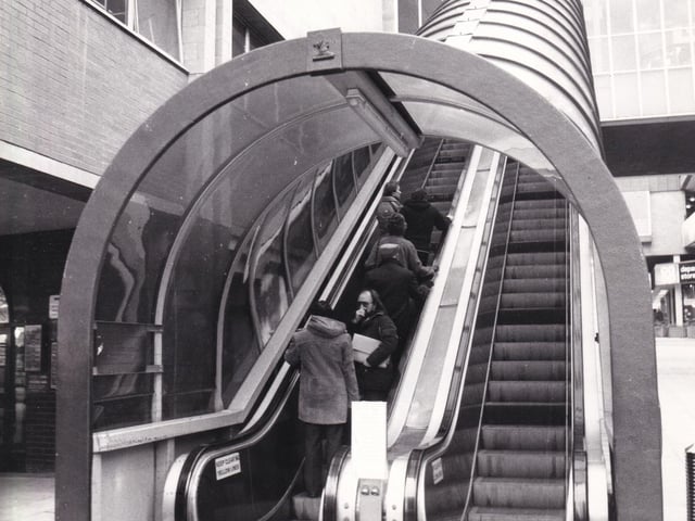 One moving staircase going up, another moving staircase coming down. The escalators on Boar Lane, pictured in November 1980.