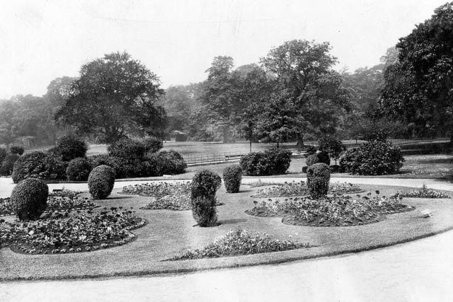 Potternewton Park with flowerbeds in the foreground.