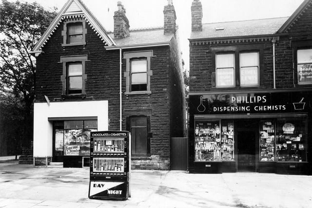 A view of 168 Chapeltown Road which was Phillips chemists.Cigarette & chocolate vending machine can be seen on the pavement. Far left is the junction with Harehills Avenue and Newton Grove.