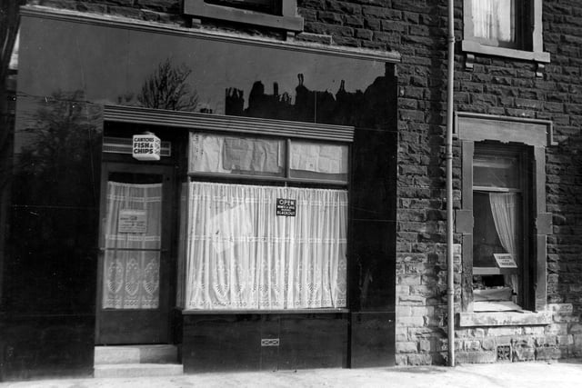 Cantors fish & Chip Shop on Chapeltown Road. Sign in window states `Open business as usual during blackout`. House on right appears to be selling cigarettes and chocolate through an open window.