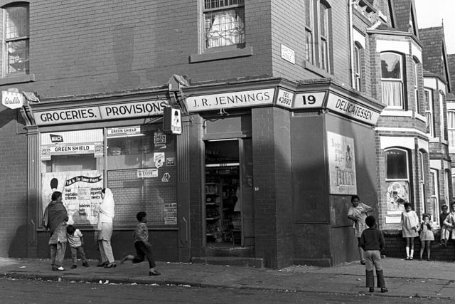 Hamilton Place showing groceries and provisions shop of J.R. Jennings. Hamilton Avenue is on the right. Children are playing in the street; their style of clothing suggest the photo dates from the late 1960s or early 1970s.